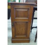 A late Victorian oak bedside cabinet with a single door,