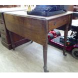 A mid 19thC mahogany Pembroke table with an end drawer, raised on turned,