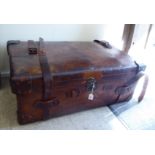 An early 20thC stitched brown hide cabin trunk with straight sides and a hinged lid,