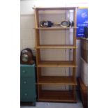 A modern pine open front bookcase of planked construction with six shelves,