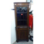 An Edwardian string inlaid mahogany corner cabinet with a broken arch pediment,