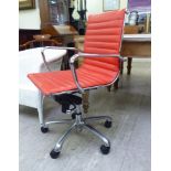 A modern desk chair, the chromium plated frame with a stitched red hide cushioned back and seat,