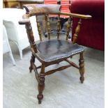 An early 20thC beech, elm and mahogany framed captains desk chair,