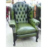 A mid 20thC Georgian style wingback part buttoned and stud green hide,