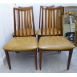 A set of four 1980s G-Plan teak framed lath back dining chairs,