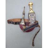 A Persian dagger, the (possibly horn) handle with yellow metal mounts, in a white metal clad,