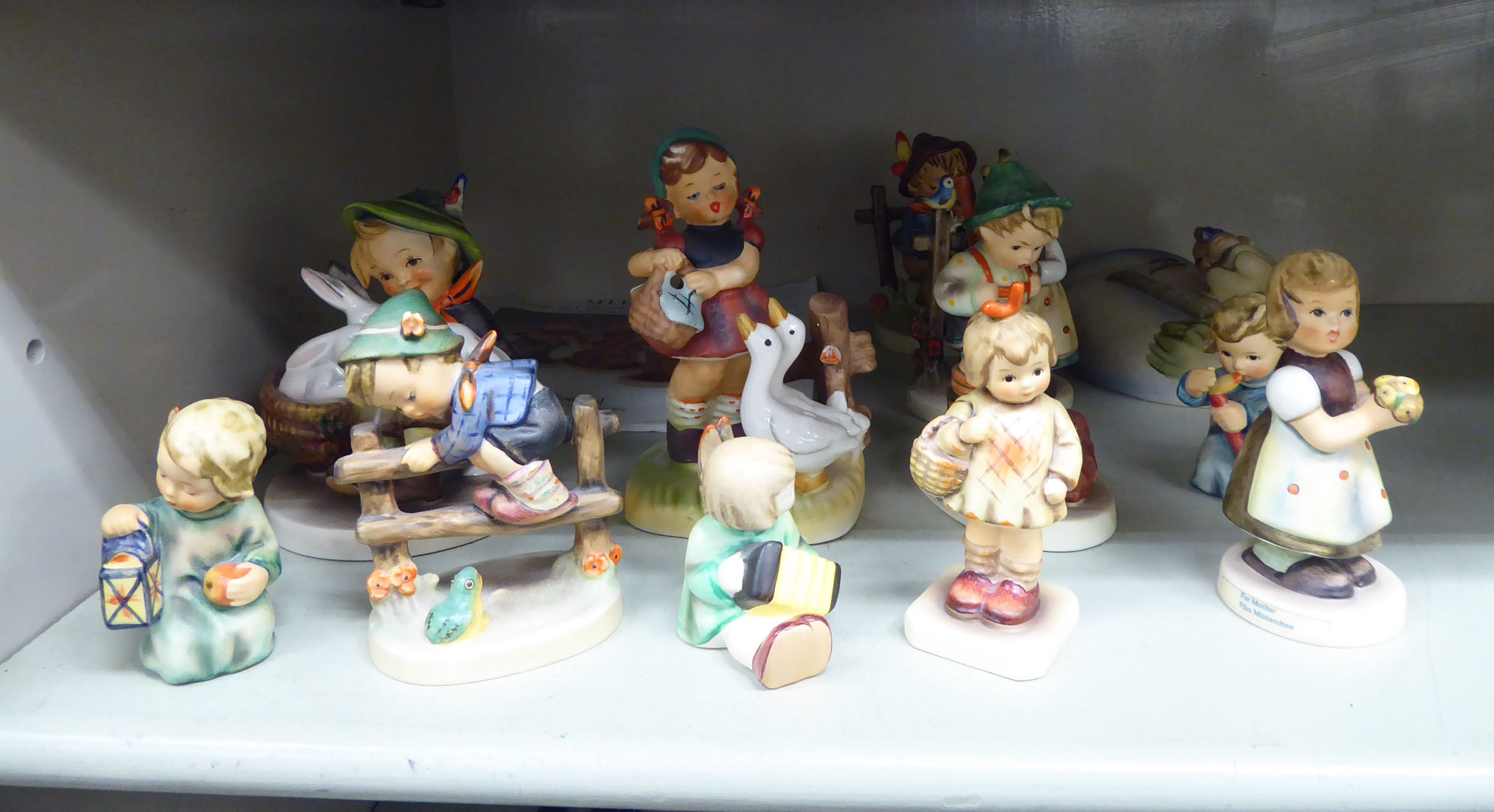 Twelve Goebel Hummel china figures: to include a young boy,