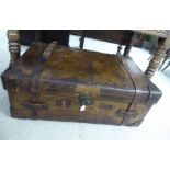 An early 20thC stitched brown hide cabin trunk with straight sides and a hinged lid,