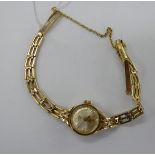 A lady's Rotary 9ct gold round cased wristwatch, on a gatelink bracelet,