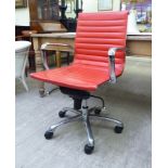 A modern desk chair, the chromium plated frame with a stitched red hide cushioned back and seat,