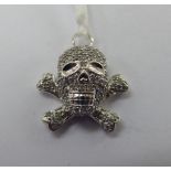 An 18ct white gold skull and crossbones pendant,