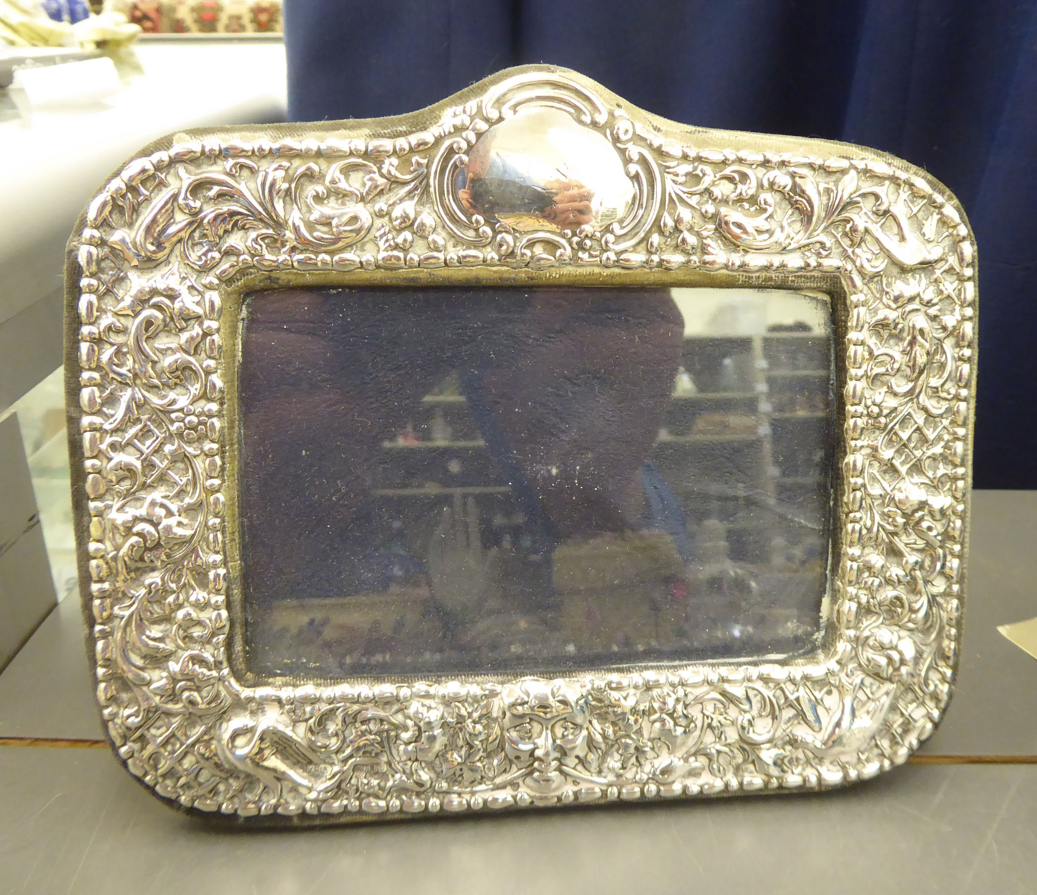 A 20thC silver mounted photograph frame with ornate swag decoration, on a blue felt,