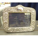 A 20thC silver mounted photograph frame with ornate swag decoration, on a blue felt,