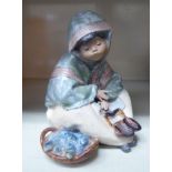 A Lladro porcelain part glazed figure,