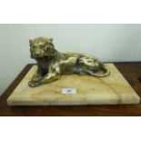 An early 20thC lacquered brass inkwell, fashioned as a seated lioness,
