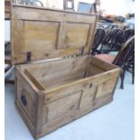 A late 19th/early 20thC rustically constructed pine chest with straight sides and a hinged lid,