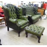 A mid 20thC Georgian style wingback, part buttoned and stud green hide upholstered armchair,