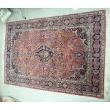 A Persian rug with floral decoration on a red ground 80'' x 53'' CS