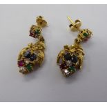 A pair of gold coloured metal pendant earrings, set with rubies,