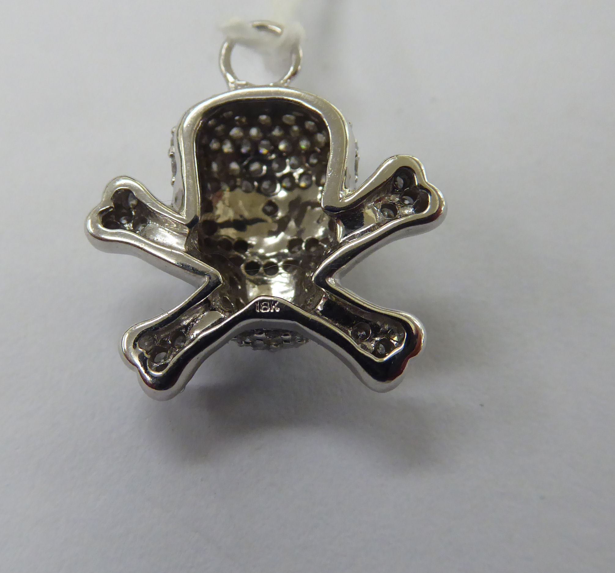 An 18ct white gold skull and crossbones pendant, - Image 2 of 2