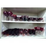 A matched set of clear and cranberry coloured pedestal drinking glasses: to include wines,