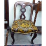 A mid Victorian mahogany framed swept, spoonback side chair with a pierced, waisted splat,