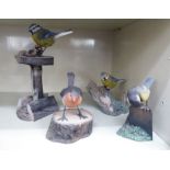 Four similar Christopher Holt & Co composition model birds: to include 'Robin on a Log' no.