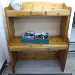 A modern pine work station with three drawers and a slide,