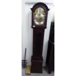 A modern mahogany cased granddaughter clock; faced by a brushed steel Roman dial,