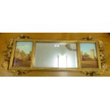 A modern Victorian style mirror with a central bevelled plate, flanked by two castle studies,