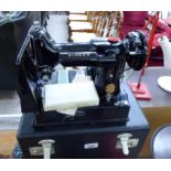 A Singer model 222K electric sewing machine with accessories cased RAM