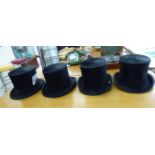 Four similar black silk top hats various sizes CA