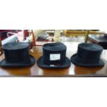 Three similar black silk top hats various sizes CA