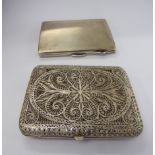 A white metal filigree cigarette case;