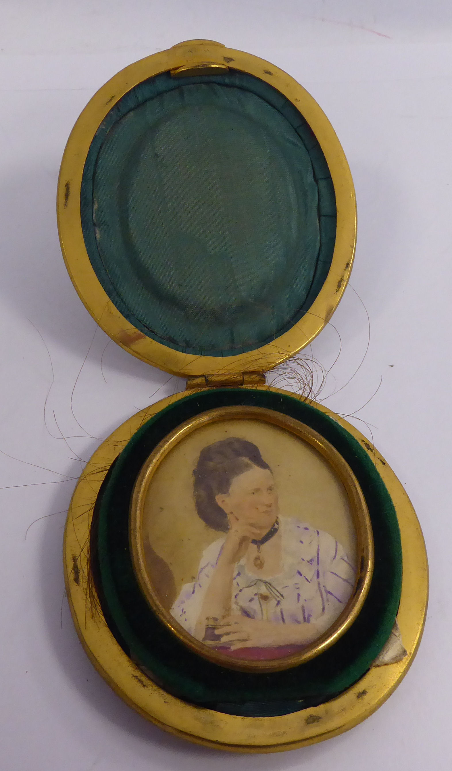 A late 19thC half-length portrait miniature, a woman holding a pair of binoculars, in a glazed,