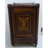 An Edwardian satinwood inlaid rosewood purdonium with a mottled marble top, over a fall flap,