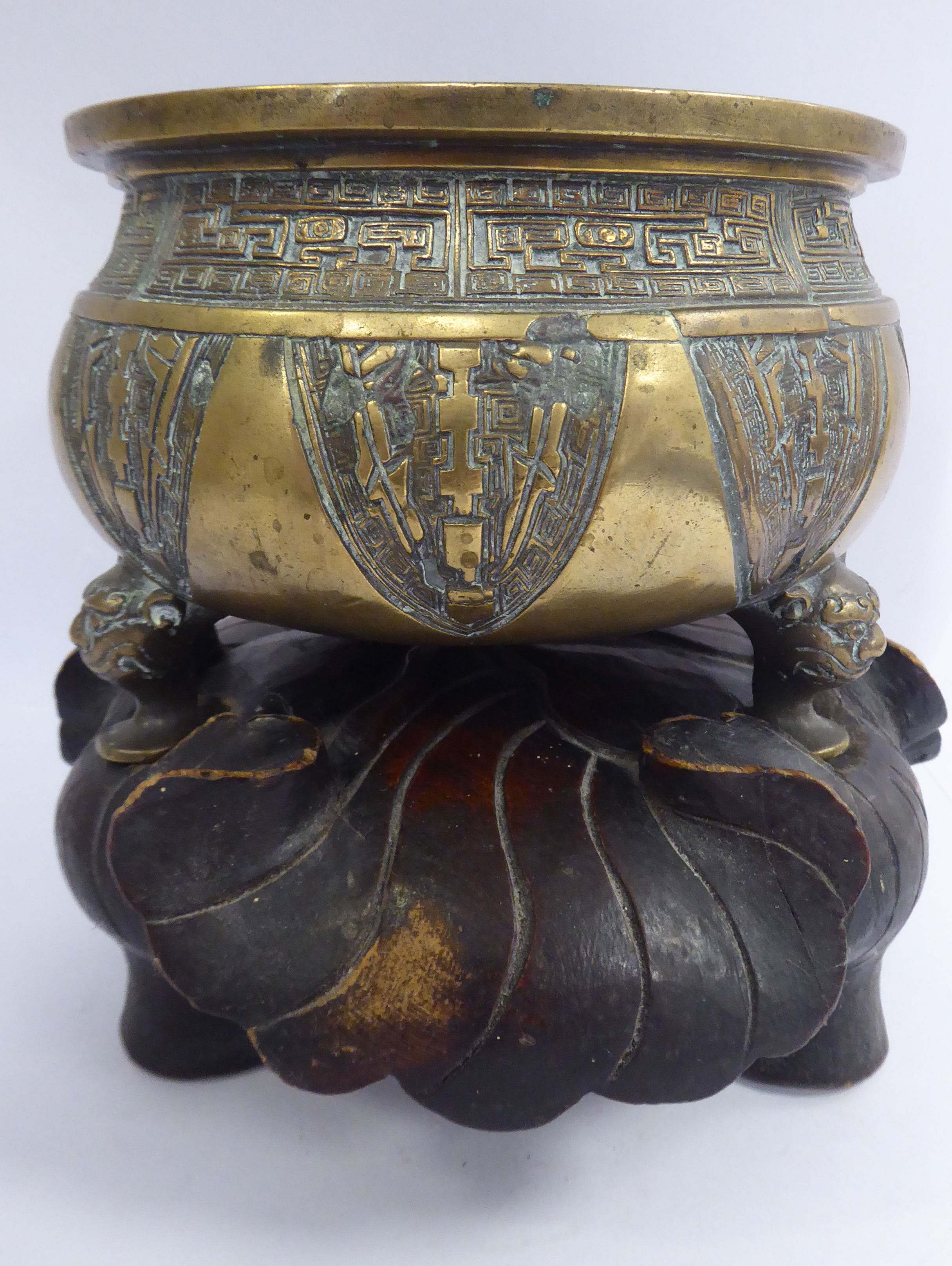 A late 18th/early 19thC Chinese bronze censor of squat, bulbous form,