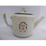 A late 18th/early 19thC Chinese porcelain armorial teapot of drum design with an angled spout,
