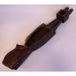 An early 20thC African tribal carved hardwood stringed musical instrument,