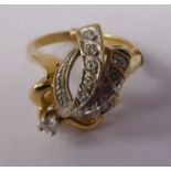 A yellow metal ring, the ornate bow design bezel,