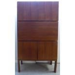 A Gordon Russell teak living room unit, Model GR69 By Robert Heritage comprising a pair of doors,