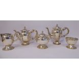 A 20thC five piece Peruvian silver coloured metal tea set with cast C-scrolled and floral