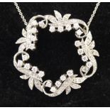 A white metal floral and foliate design pendant, set with twenty-five diamonds,