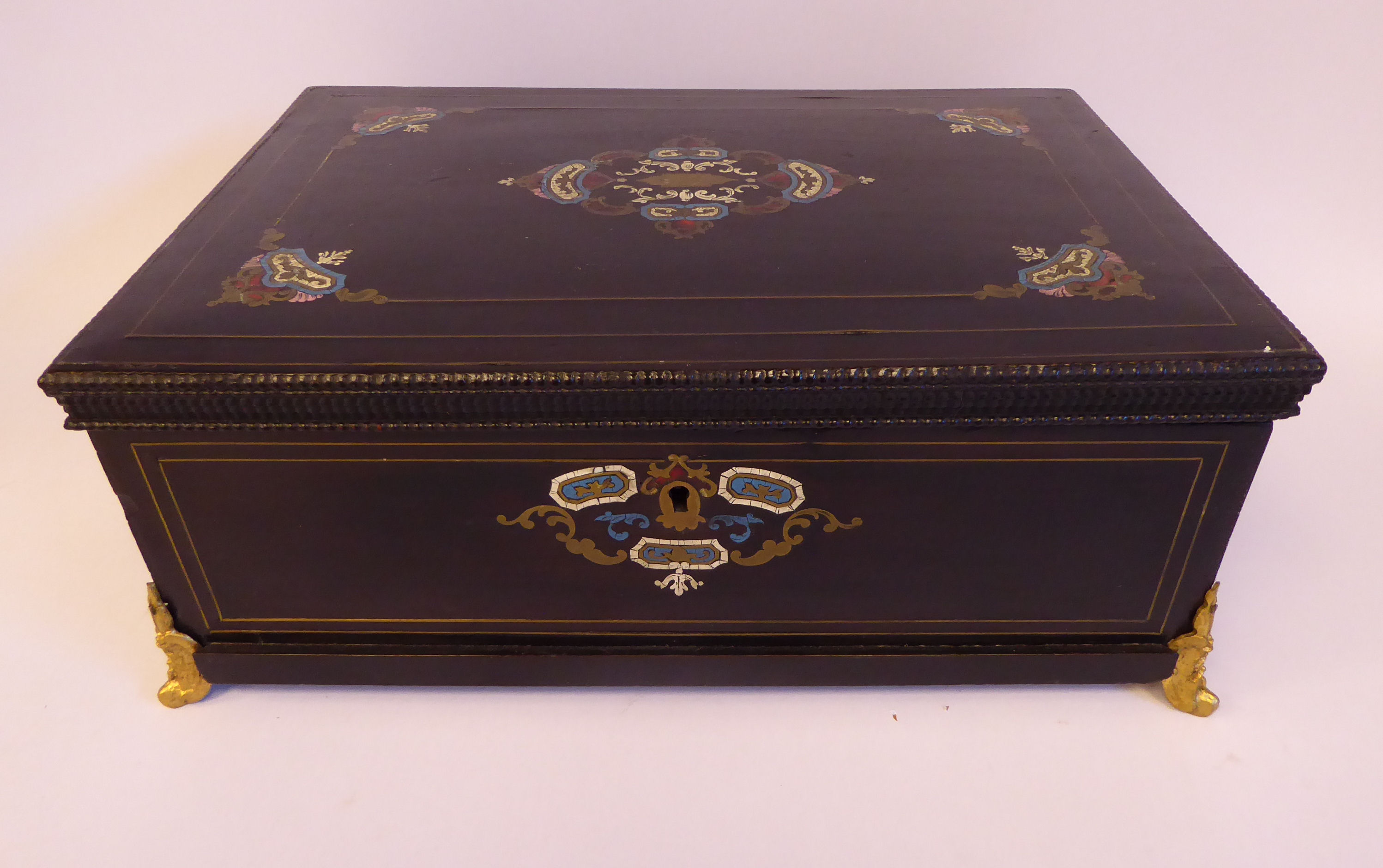 A late Victorian brass tortoiseshell and turquoise inlaid, ebonised box with a hinged lid,