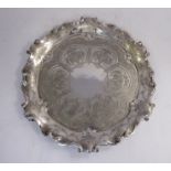 A late Victorian silver waiter with a twin C-scrolled wavy border and engraved foliate ornament,