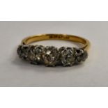 A gold coloured metal five stone, claw set diamond ring,