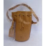 A Louis Vuitton stitched brown hide Champagne bottle sleeve with a string pull neck and carrying