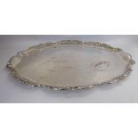 A silver oval serving tray with a decoratively cast,