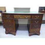 An early 20thC lady's bow front mahogany kneehole desk,