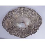 A late Victorian silver oval dish, decorated with embossed and chased flora,